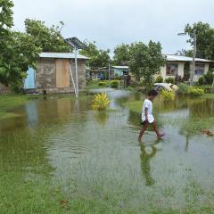 Shutterstock image - Girl walking across flood waters
